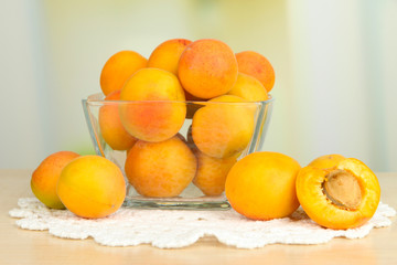 Fresh natural apricot in bowl on table in kitchen