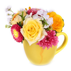 Beautiful bouquet of bright flowers in color mug, isolated