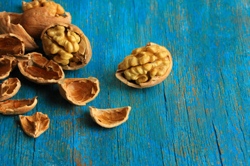 Broken walnuts on wooden table close-up