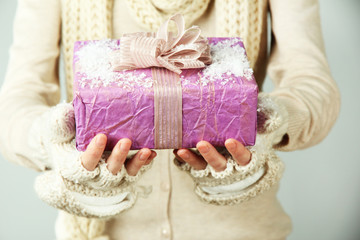 Fototapeta na wymiar Female hands with gift box, close-up