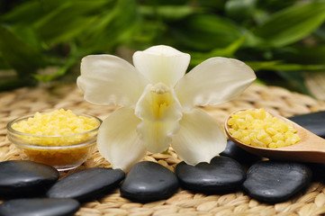 Fototapeta na wymiar SPA background. Salt in bowl and stones with orchid on mat