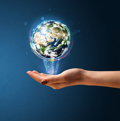 Woman holding a glowing earth globe