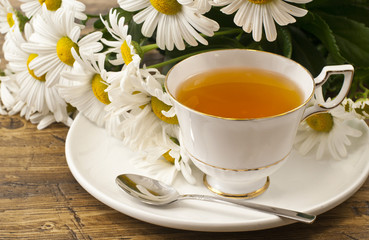 Cup of herbal tea with chamomile flowers