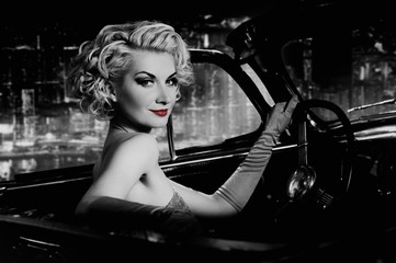 Woman with red lips in retro car against night city