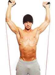 Handsome man with muscular body doing fitness exercise