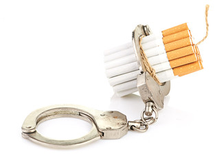Addition concept with cigarettes and handcuffs