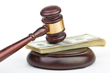 Law gavel on a stack of American money.