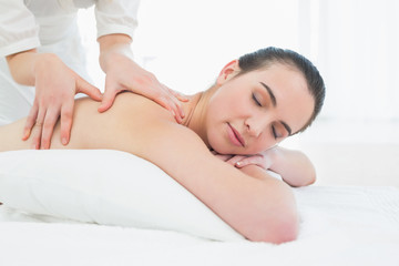 Fototapeta na wymiar Beautiful woman enjoying back massage at beauty spa