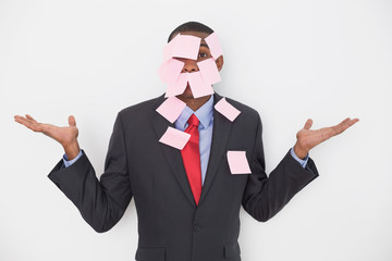 Portrait of an Afro businessman covered in blank notes