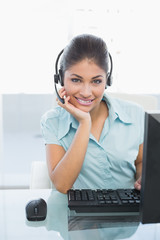 Businesswoman wearing headset while using computer