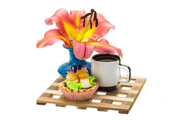 Coffee with cupcake and lilly flower