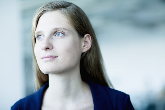 Portrait Of Young Businesswoman Looking Away In Contemplation