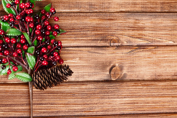 branches with Christmas berries on wooden panels