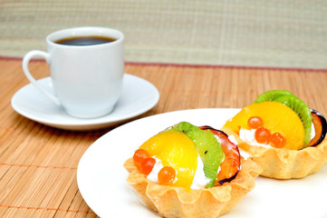Fruit cake on a plate and a cup of coffee