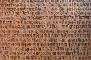 Foto op Canvas Achtergrond met oude Sanskriettekst geëtst in een stenen tablet © salajean