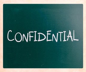 The word "Confidential" handwritten with white chalk on a blackb