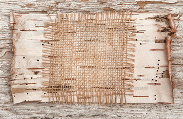 Burlap and birch bark on the old wood