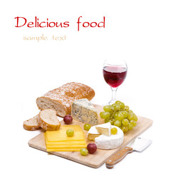 Cheese platter, grapes, ciabatta and glass of red wine, isolated