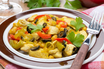 chicken stew with chickpeas, peppers and onions, close-up