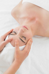 Obraz na płótnie Canvas Hands massaging woman's face at beauty spa