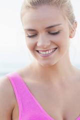 Close up of a smiling healthy woman looking down