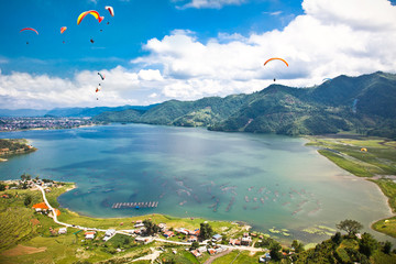 Paraglider flying over the  Fewa lake in Pokhara, Nepal. - 57953669