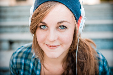 beautiful young blonde hipster woman listening music