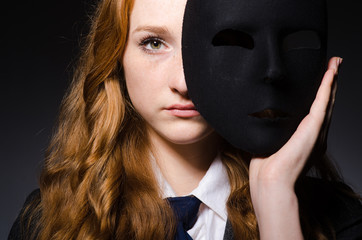 Woman with mask in hypocrisy concept