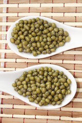 mung beans on white ceramic spoon