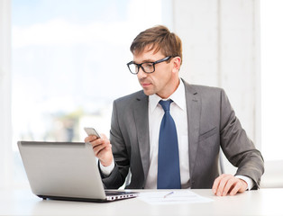 businessman working with laptop and smartphone