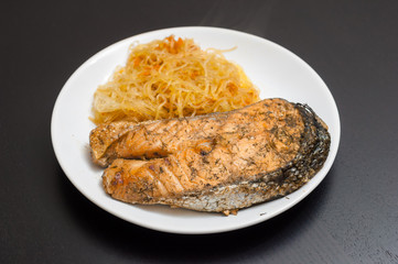 Salmon steak served with funchoza noodles