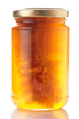 Honey with honeycombs in glass jar, isolated
