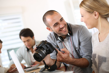 Students in photography working together on project