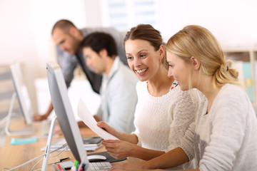 College girls working in front of desktop