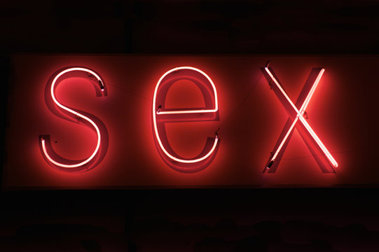 SEX hot red neon on black background