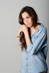 Young casual woman style over gray background. Studio portrait