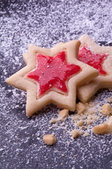 christmas star cookies with red jelly and powder sugar