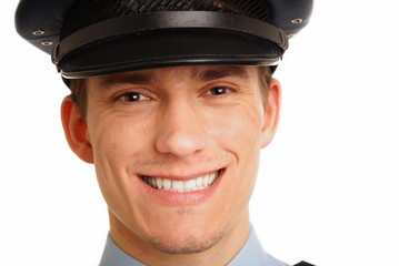 Portrait of smiling young policeman close up.