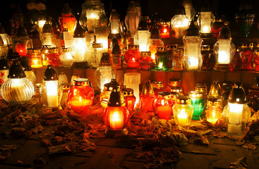 Candles on the grave on the evening of All Saints Day in Poland.