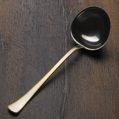 Ladle on wooden plank