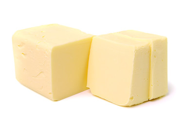 Stick of butter, cut, isolated on white.