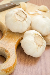 Garlics with cutting board and knife