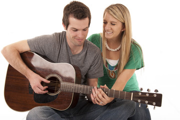 Young couple holding hands playing guitar