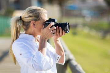 amateur middle aged photographer taking pictures outdoors