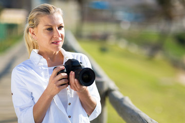 thoughtful amateur photographer holding camera