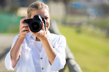 mature female photographer taking photos