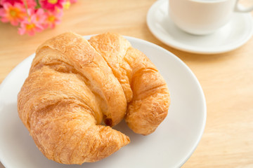 Fresh croissant with coffee cup
