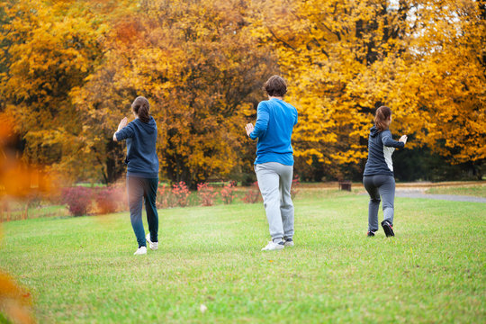 Practicing Tai Chi In Park