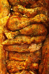 Closeup raw marinated chicken meat drumstick