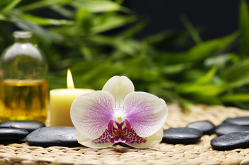 Obraz na płótnie Canvas spa concept with orchid with spa stone, candle, massage oil